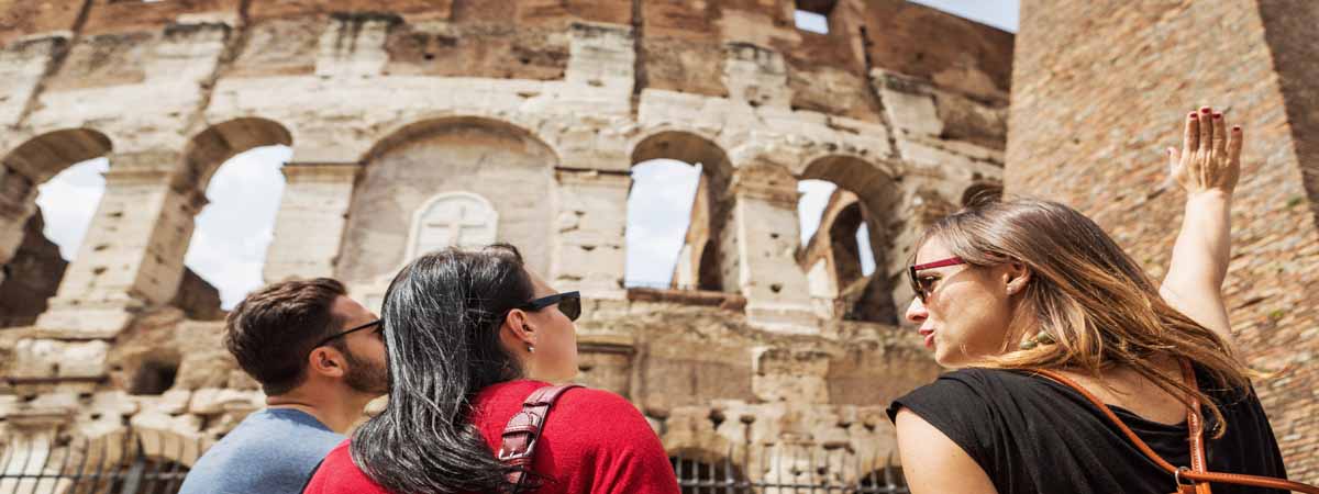 Small group of travelers on a guided tour of the Colosseum in Rome, Italy