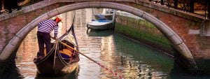 Venice Gondolier Under Bridge Canal