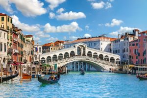 Gondolas at the Rialto Bridge on the Grand Canal in Venice, Veneto, Italy
