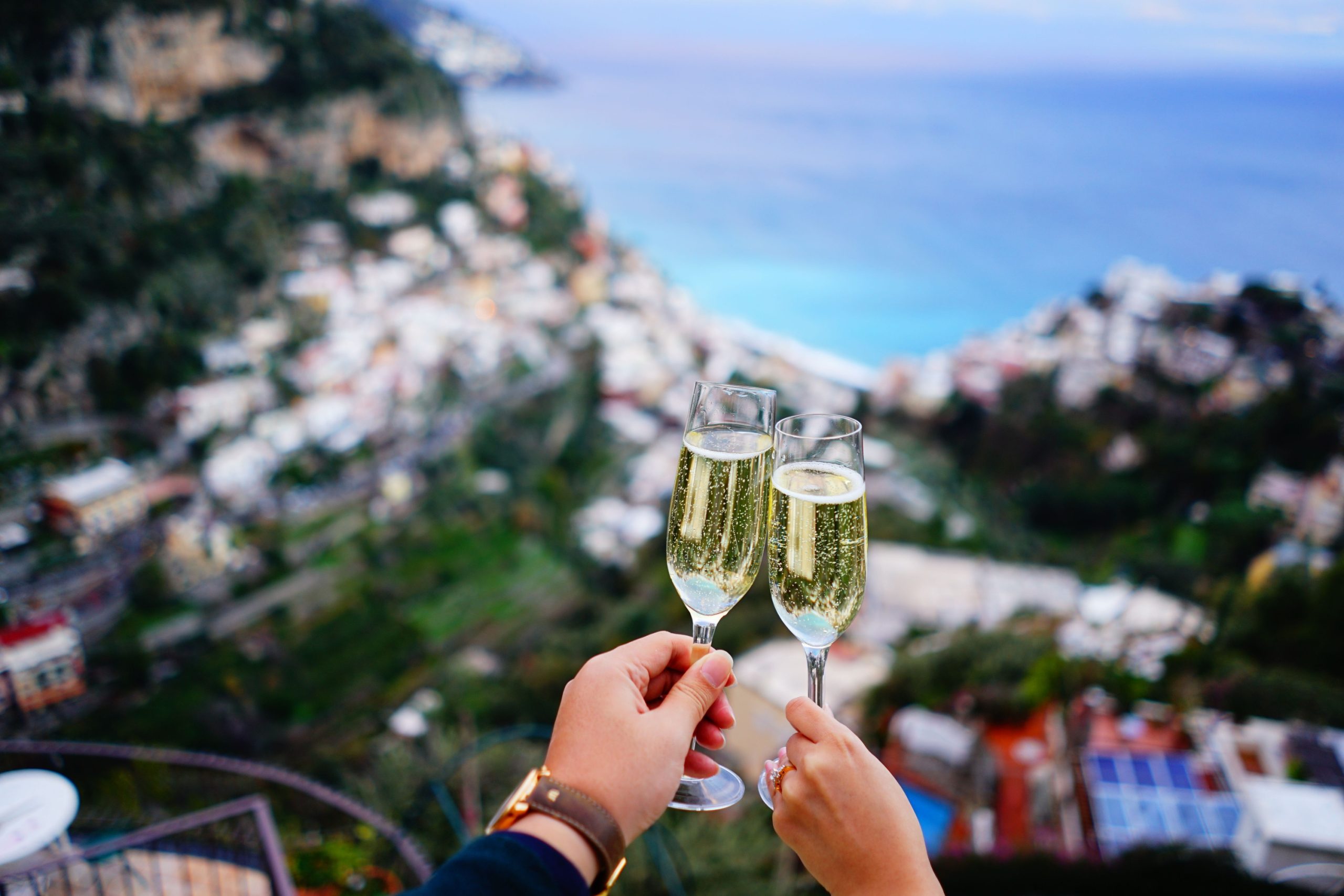 Champagne toast on a terrace above an Amalfi Coast town