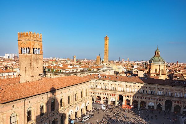 View over the terracotta rooftops of Bologna toward its medieval towers and Piazza Maggiore, Emilia-Romagna, Italy