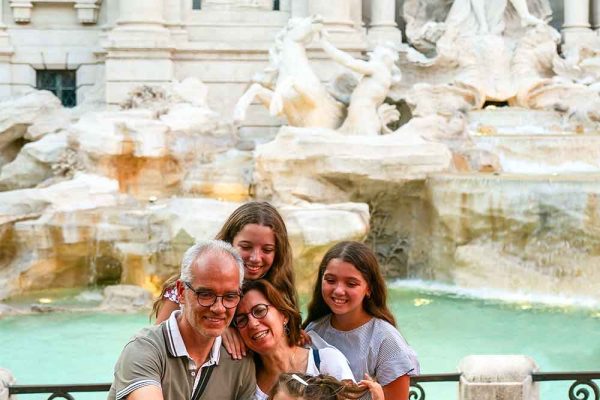 Family with children at the Trevi Fountain in Rome, Italy