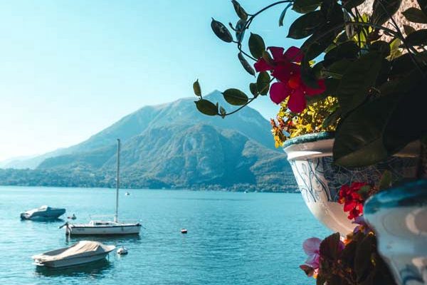 Boats on the water and villages along the shore of Lake Como